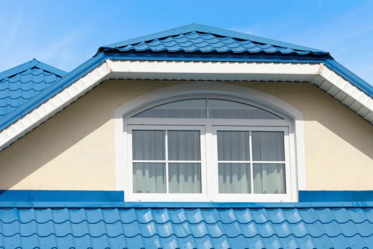 modern house with a big window and blue metal roofing