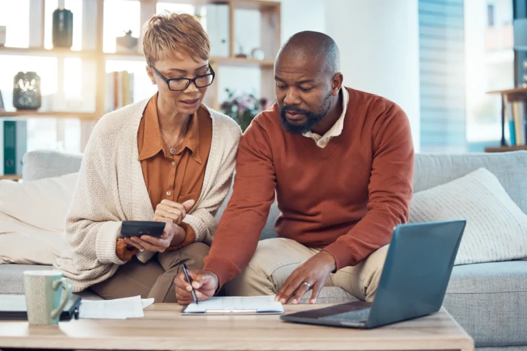 homeowner couple reviewing their home insurance documents at home