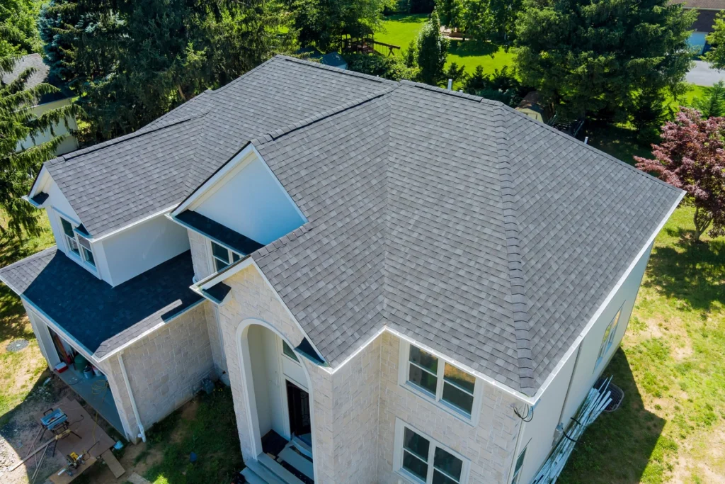 Downward aerial view of shingle roof newly installed on residential home
