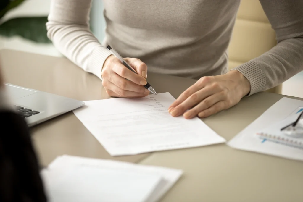 woman signing a warranty