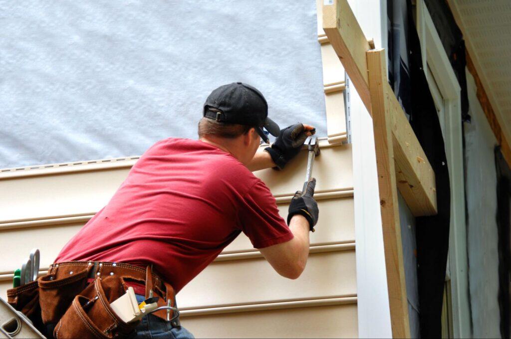a contactor installing siding