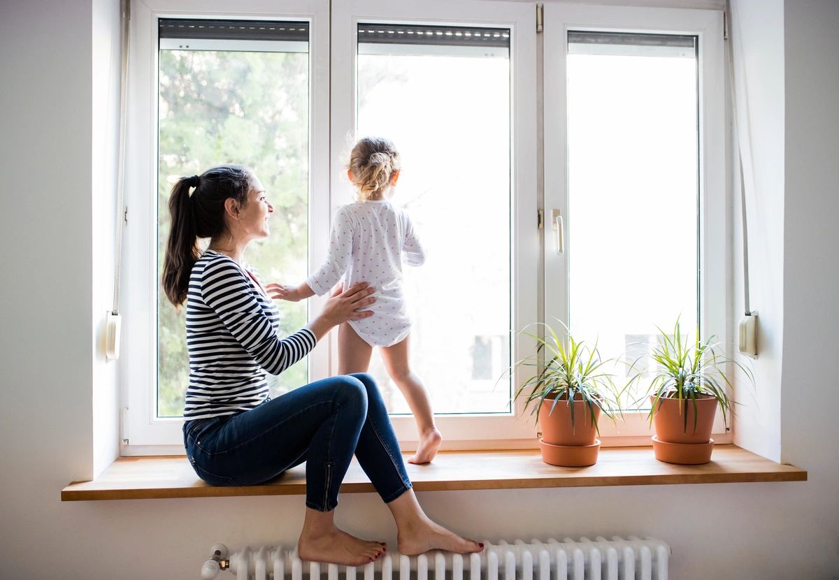 mom and kid looking out window